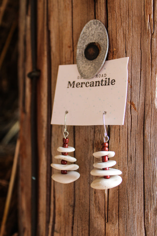 white layered earrings with rust beads between